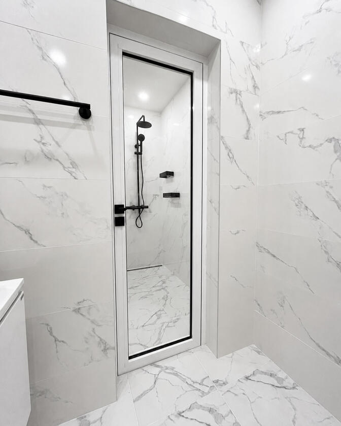 Bathroom-facing side Water- and moisture-resistant bathroom-facing side of a two-in-one door
