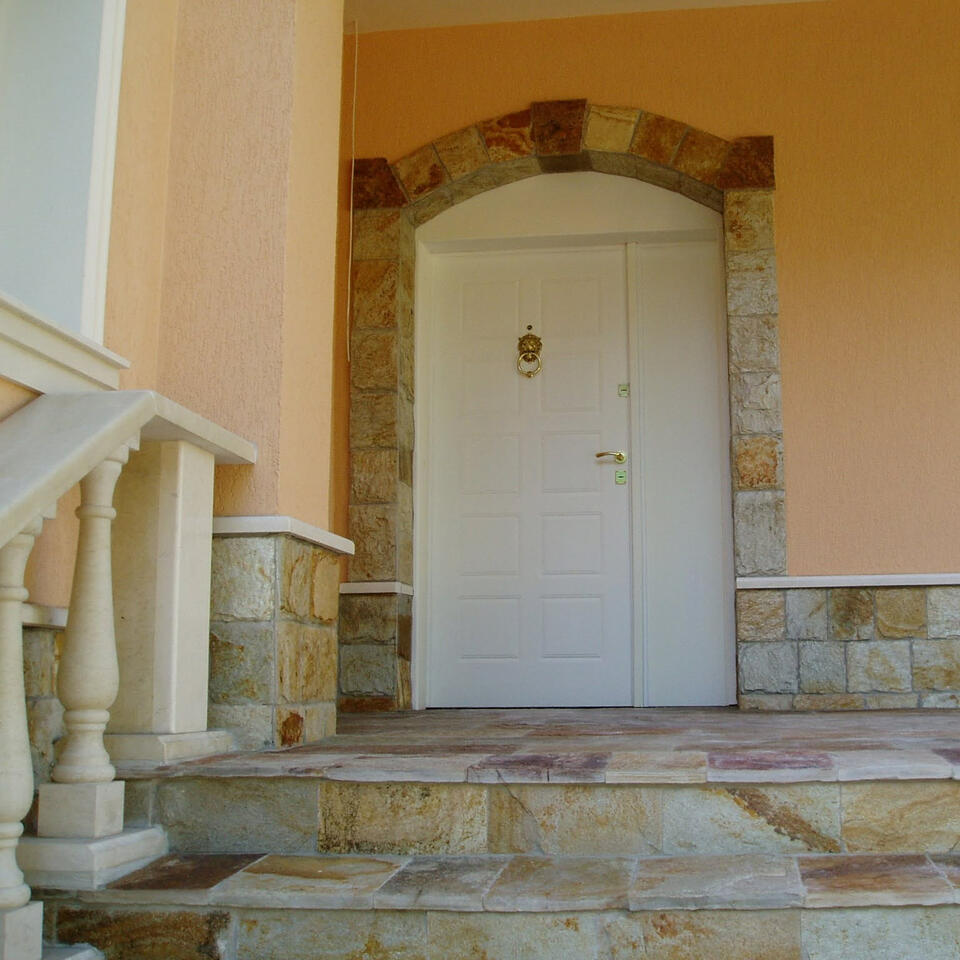 Complete white made-to-measure exterior entrance door with matching side panel and stone arch