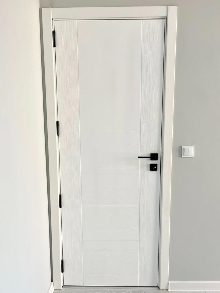 Complete white custom interior door with full frame and architraves visible