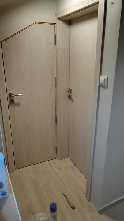 Custom interior doors manufactured for an irregular sloped ceiling opening